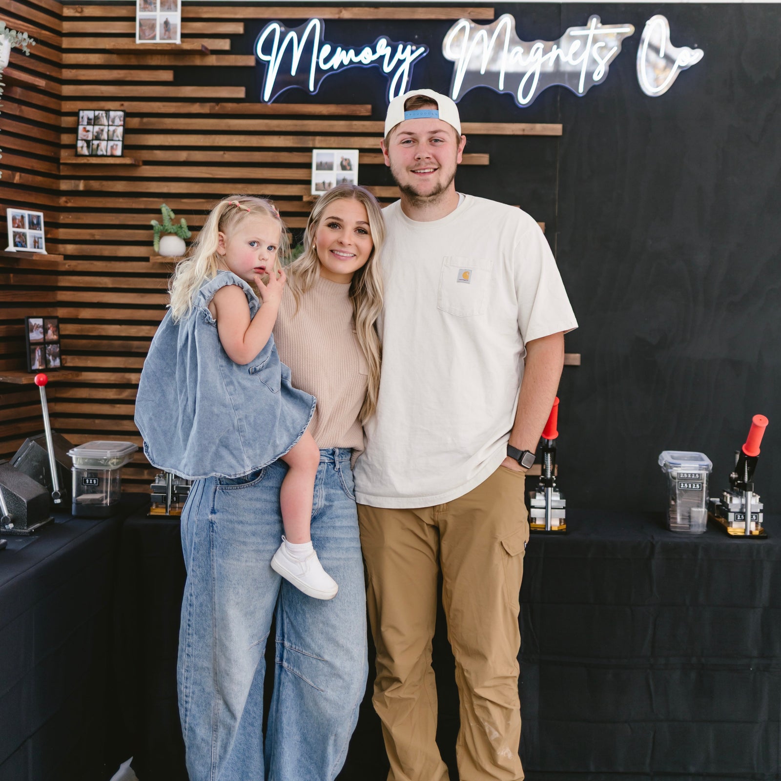 Sariah Howell founder of Memory Magnets Co holding a professional photo magnet making machine